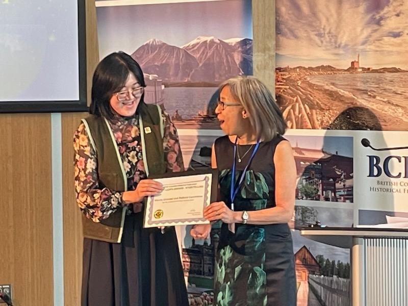 Mandy Shintani stands with Sarah Ling holding the Bright Lights Award for Storytelling at the British Columbia Historical Federation Annual Conference on May 30, 2026.